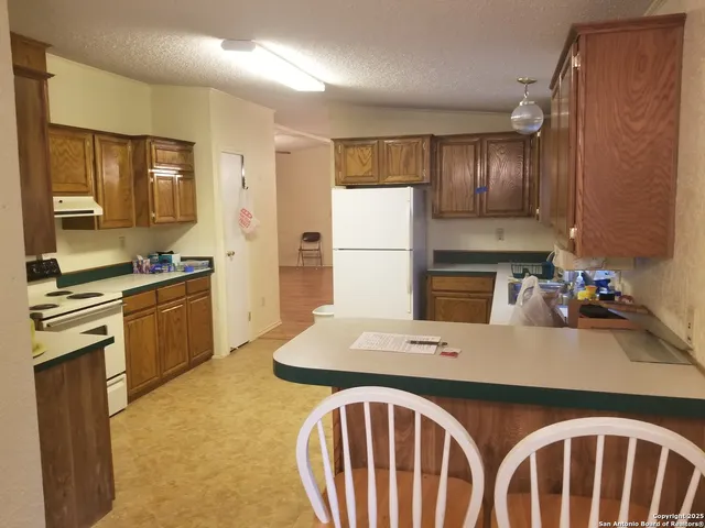 a kitchen with a sink stove and refrigerator