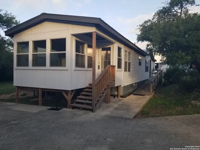 a small white house with a white door