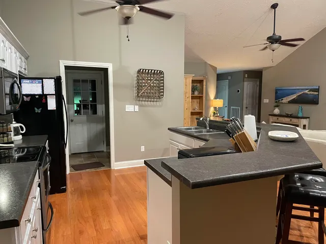 a kitchen with a sink a counter top space and stainless steel appliances