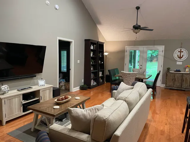 a living room with furniture and a flat screen tv