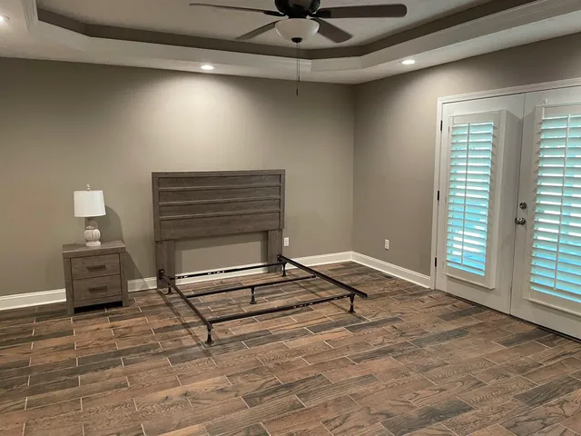 a living room with a furniture and a ceiling fan