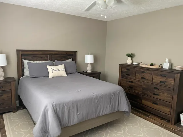 a bedroom with a bed and lamp