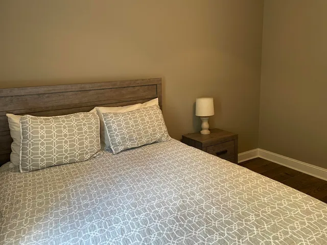 a bedroom with a bed and a night stand