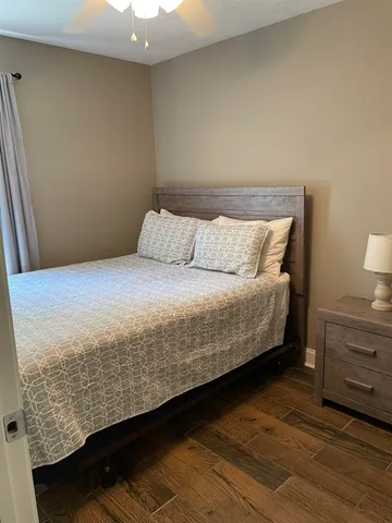 a bedroom with a bed and dresser