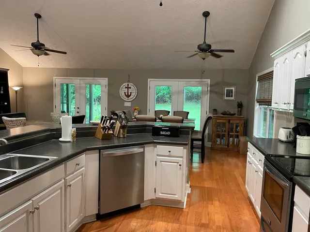 a kitchen with a sink stainless steel appliances and cabinets