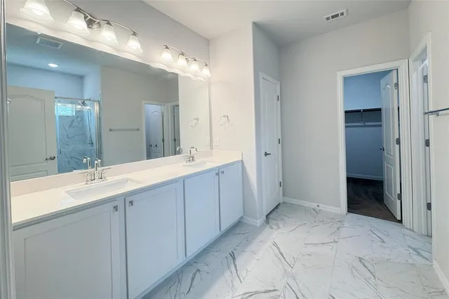 a spacious bathroom with a double vanity sink shower and a mirror