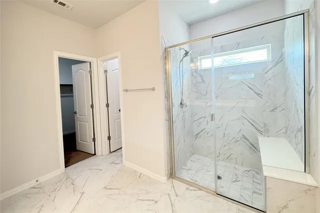 a bathroom with a glass shower door