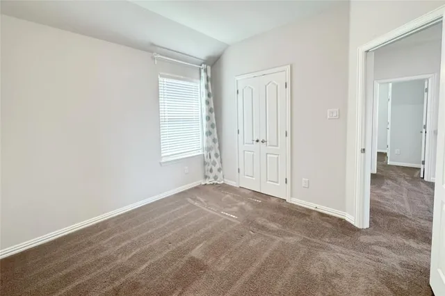 a view of a hallway with wooden floor and stairs