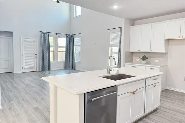 a kitchen with a sink and cabinets