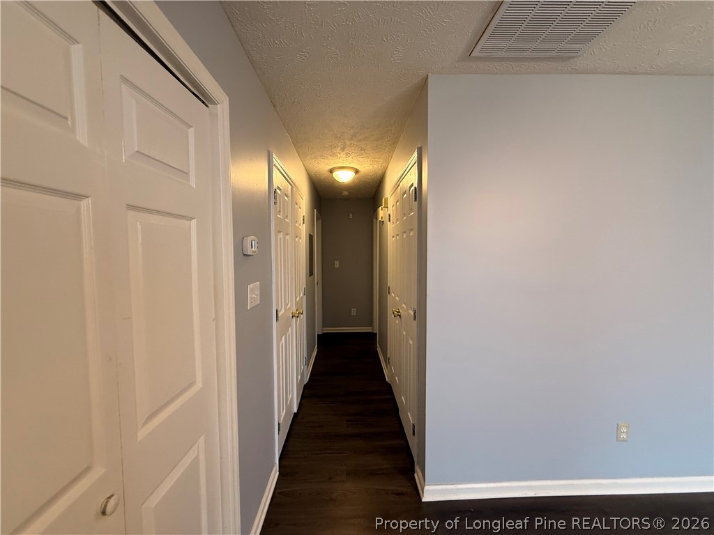 231 Bahia Lane Raeford, NC 28376 - Photo 5 of 10 a view of a hallway with wooden floor