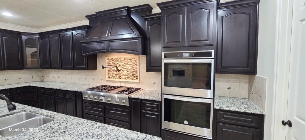 127 Bridgewater Onalaska, TX 77360 - Photo 10 of 34 a kitchen with granite countertop stainless steel appliances and wooden cabinets