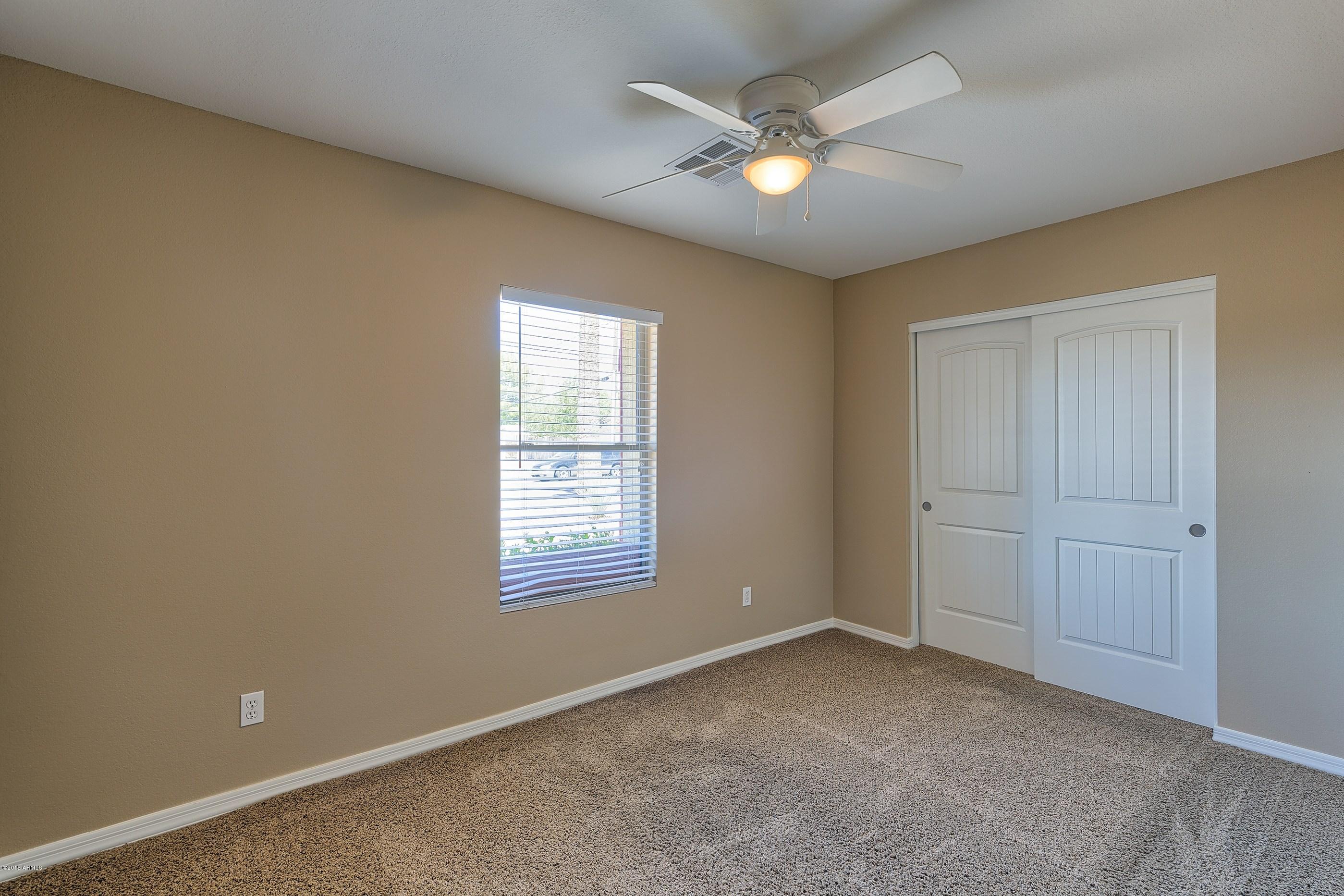1601 North 13th Avenue Phoenix, AZ 85007 - Photo 11 of 18 an empty room with windows and ceiling fan