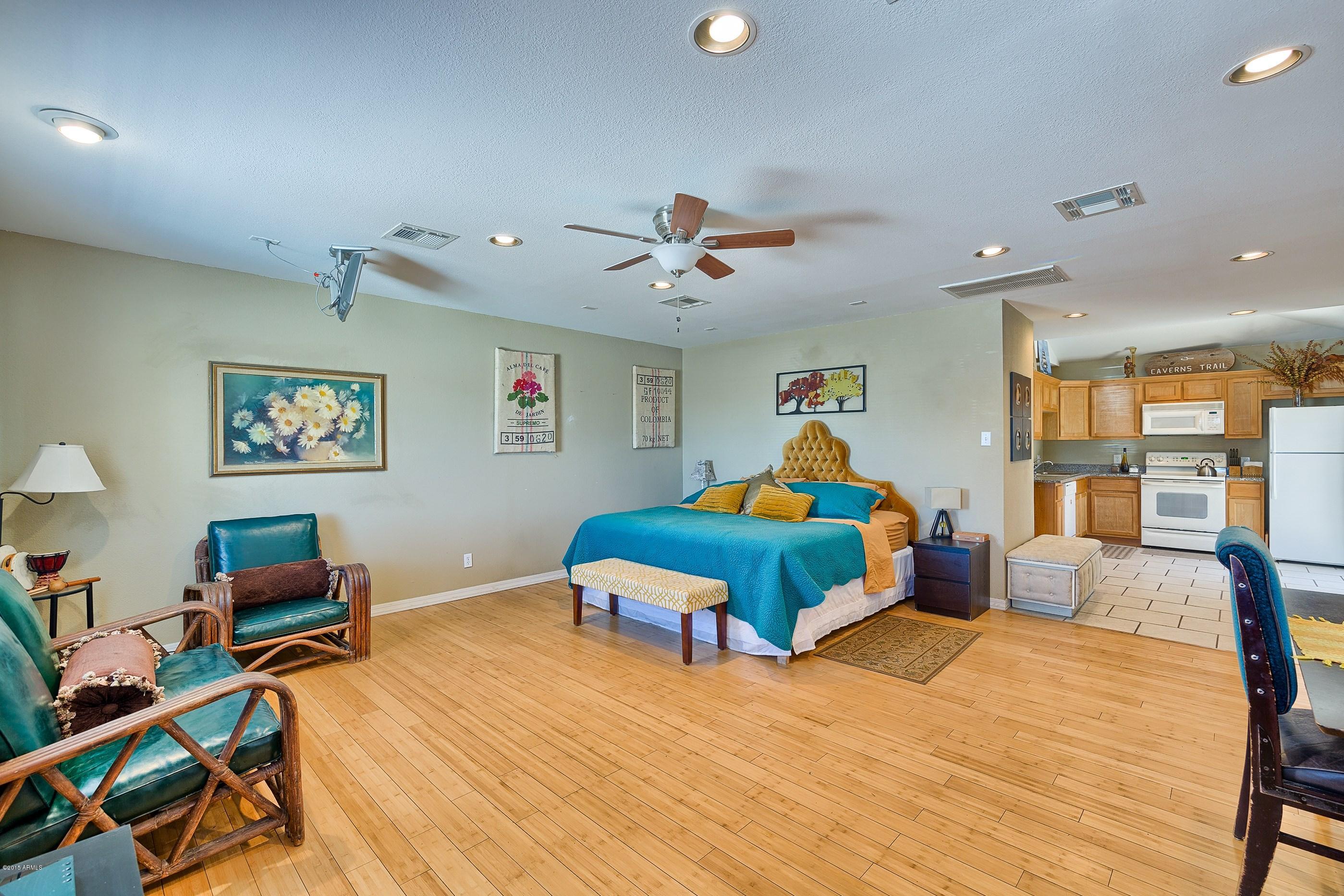 1601 North 13th Avenue Phoenix, AZ 85007 - Photo 13 of 18 a bedroom with a bed and wooden floor