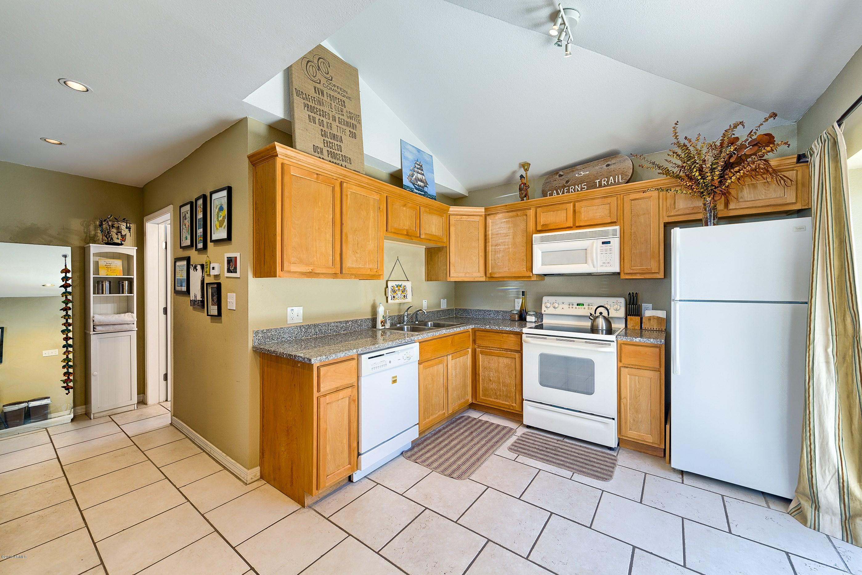 1601 North 13th Avenue Phoenix, AZ 85007 - Photo 15 of 18 a kitchen with stainless steel appliances granite countertop a refrigerator and a stove top oven