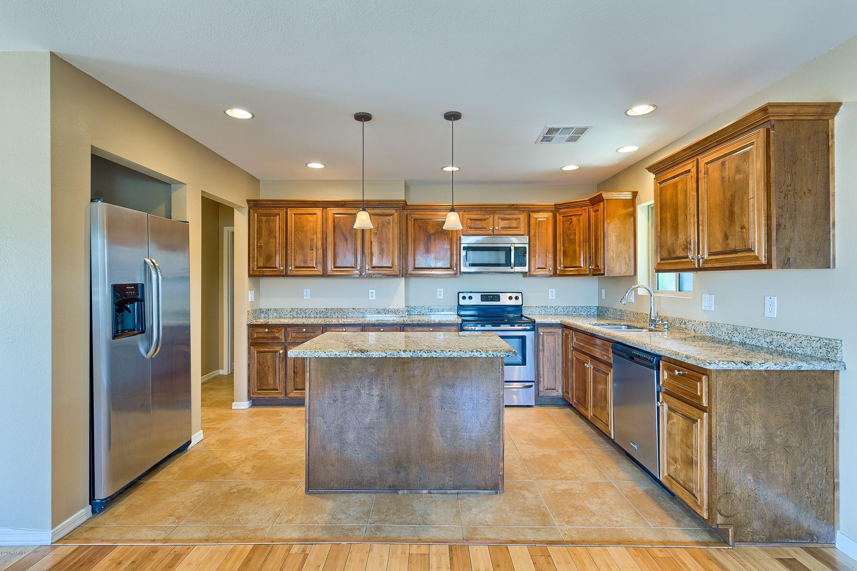 1601 North 13th Avenue Phoenix, AZ 85007 - Photo 7 of 18 a kitchen with stainless steel appliances granite countertop a stove a sink a refrigerator and a oven