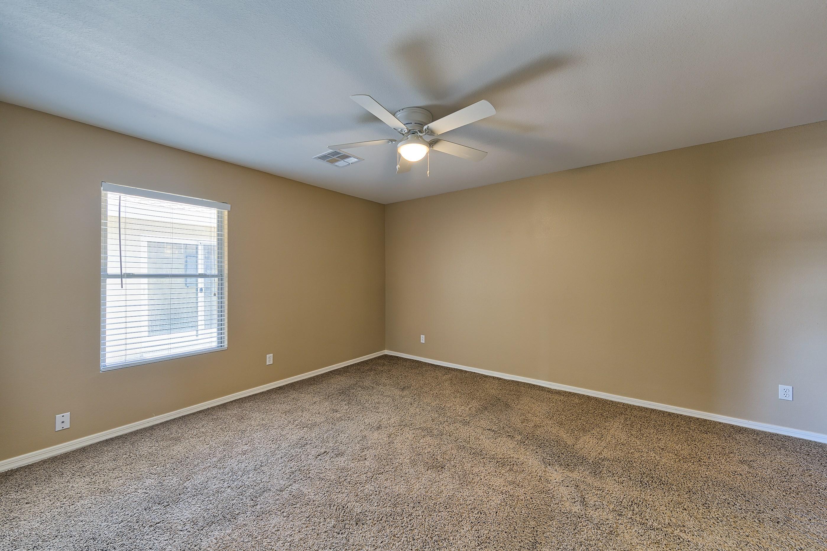 1601 North 13th Avenue Phoenix, AZ 85007 - Photo 8 of 18 an empty room with a window and a ceiling fan