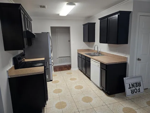 a kitchen with a sink and a refrigerator