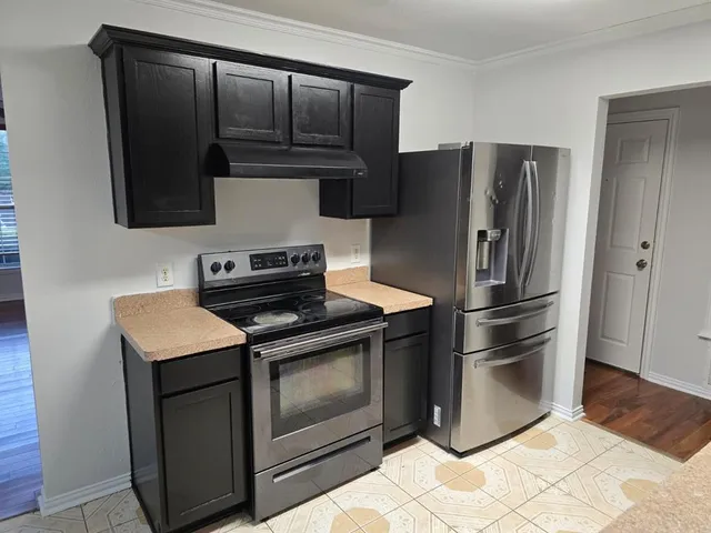 a kitchen with a stove microwave and refrigerator