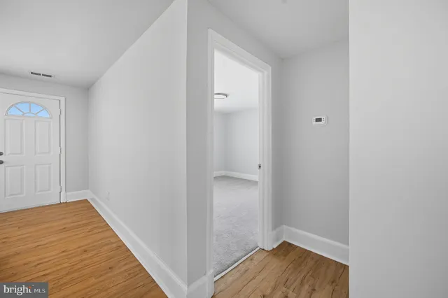 a view of a bathroom with wooden floor and a sink
