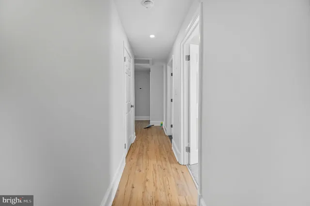 a view of a hallway with wooden floor