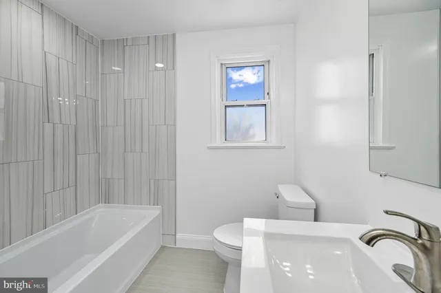 a bathroom with a sink a toilet and a bathtub