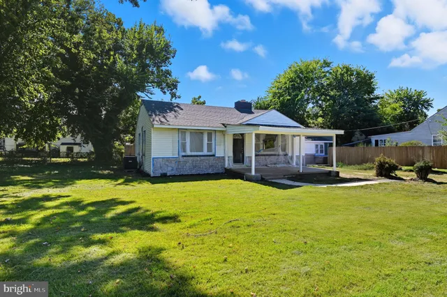 a swimming pool with outdoor seating and yard