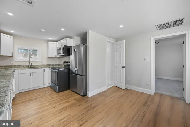 a kitchen with a refrigerator and a sink