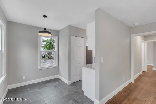 a view of an empty room with a window