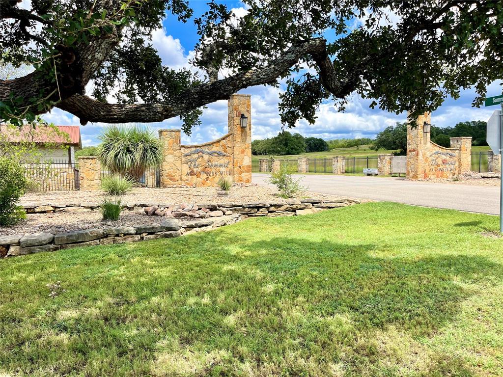 428 Summit Spring Lane Johnson City, TX 78636 - Photo 1 of 19 a view of a patio with table and chairs under an umbrella