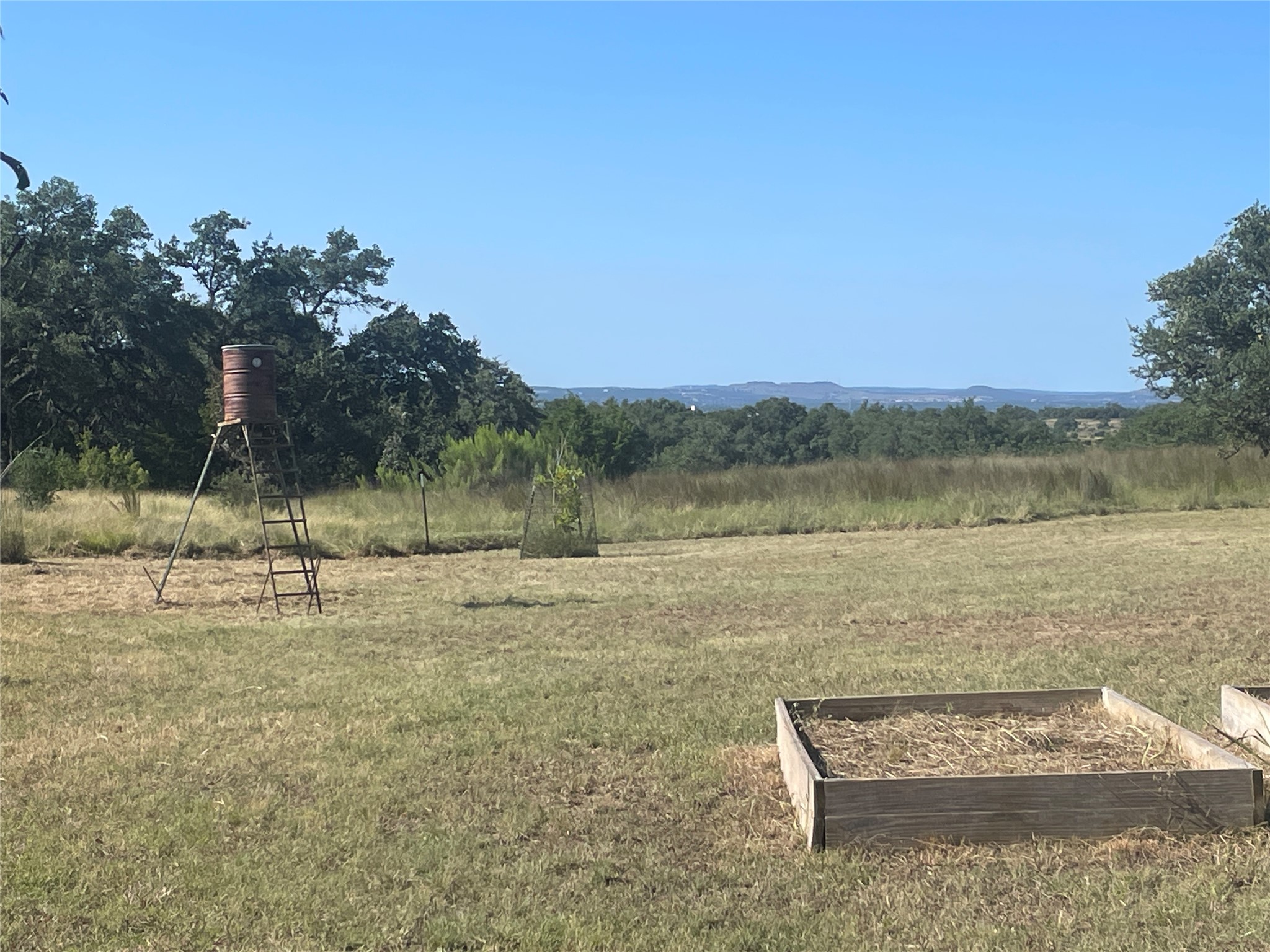 428 Summit Spring Lane Johnson City, TX 78636 - Photo 19 of 19 a view of a lake with houses in the background