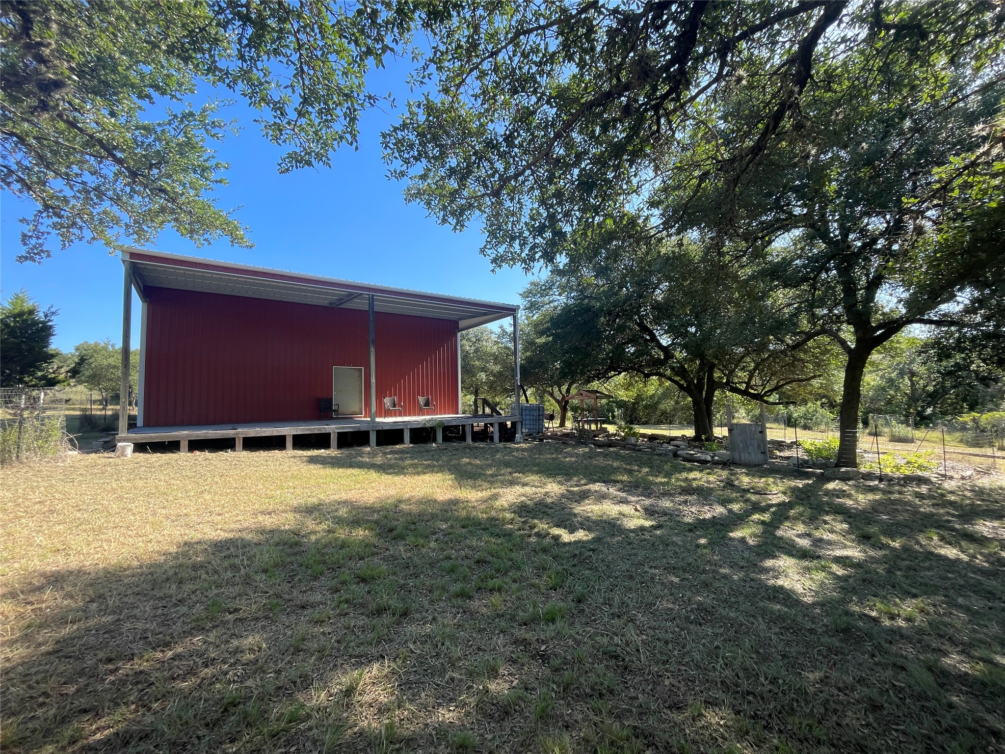 428 Summit Spring Lane Johnson City, TX 78636 - Photo 2 of 19 a view of a backyard with large trees