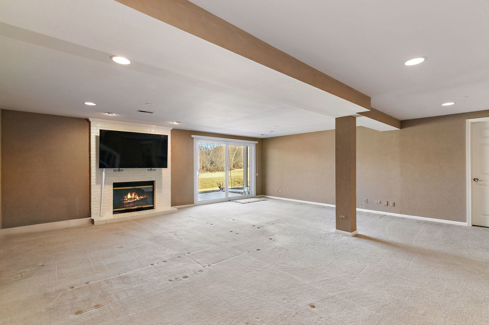 814 Oak Hill Road Lake Barrington, IL 60010 - Photo 27 of 59 a view of a livingroom with a flat screen tv and fireplace