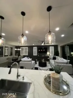 a kitchen with stainless steel appliances kitchen island granite countertop a sink a stove and chairs