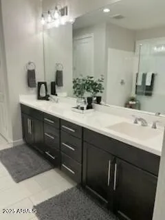 a bathroom with a double vanity sink and a mirror