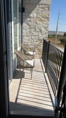 a view of balcony with wooden floor