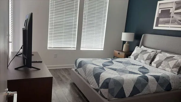 a bedroom with a bed and a window