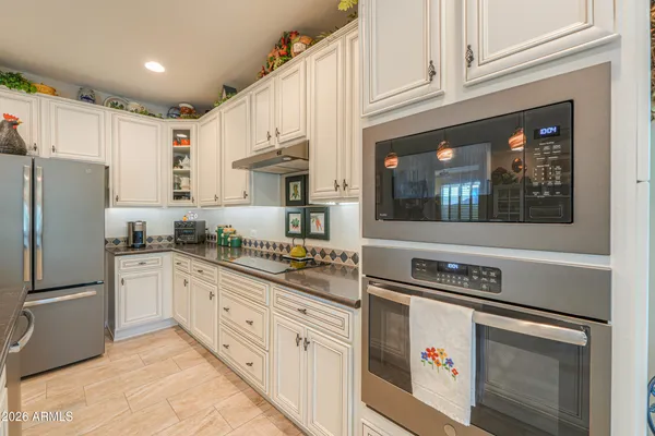 a backyard of a house with large trees and plants