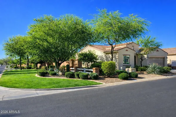 a kitchen with stainless steel appliances kitchen island granite countertop a refrigerator a stove a oven a sink with a dining table and chairs