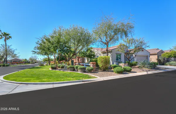 a kitchen with stainless steel appliances granite countertop a stove a refrigerator a oven a sink a dining table and chairs with wooden floor