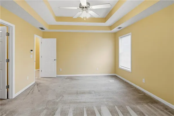 a white toilet sitting next to a white wall