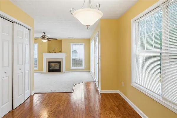 a view of an empty room with a window and fireplace