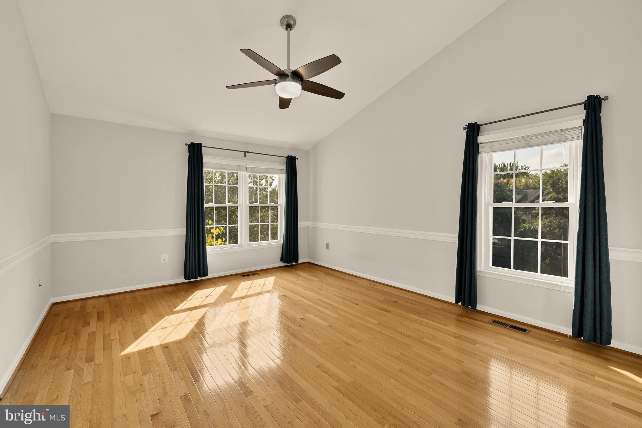 3015 Fallswood Glen Court Falls Church, VA 22044 - Photo 19 of 36 a view of an empty room with a window and wooden floor