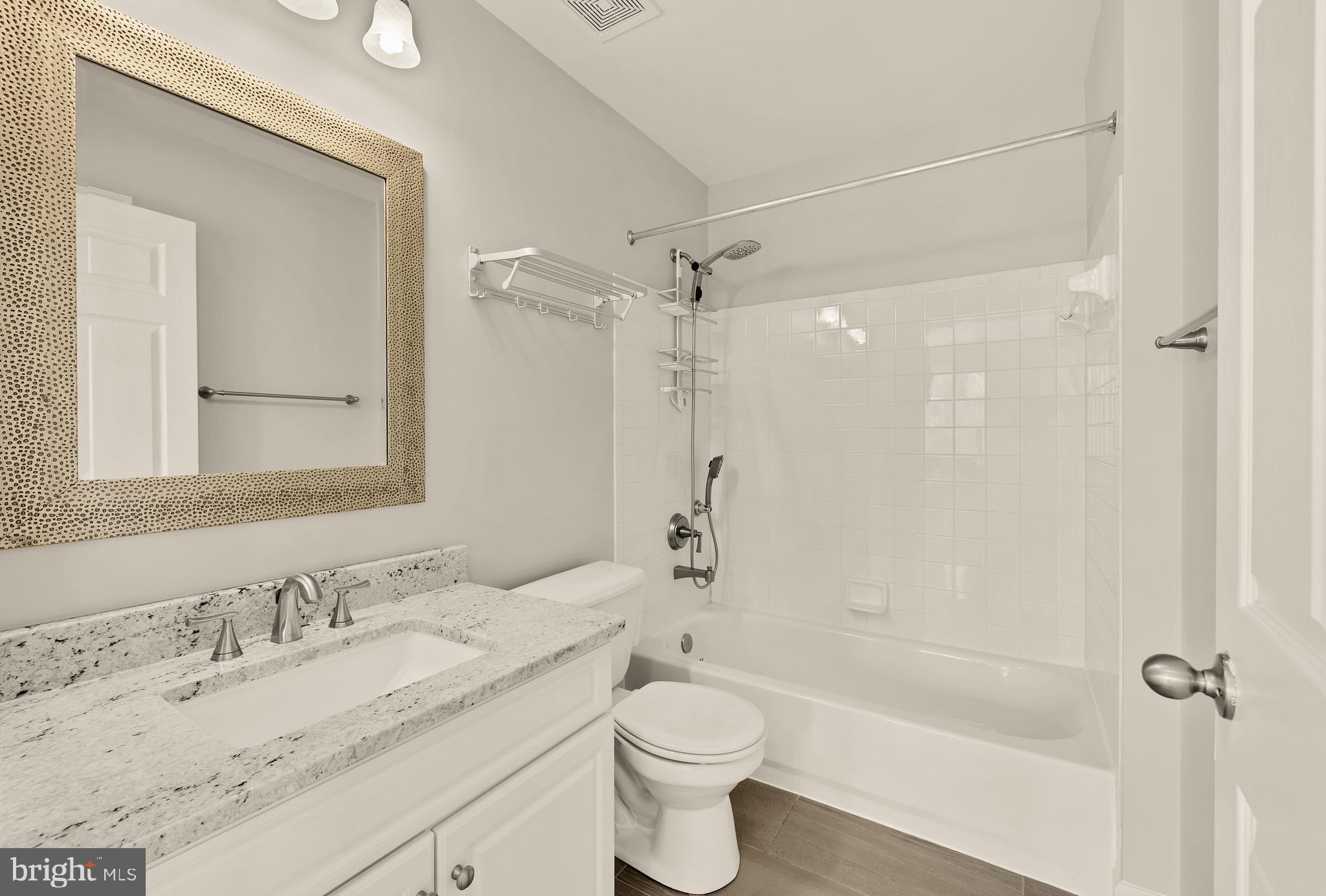 3015 Fallswood Glen Court Falls Church, VA 22044 - Photo 26 of 36 a bathroom with a granite countertop sink toilet and shower