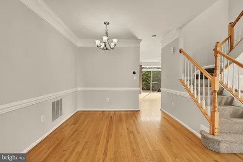 a view of a room with wooden floor and staircase