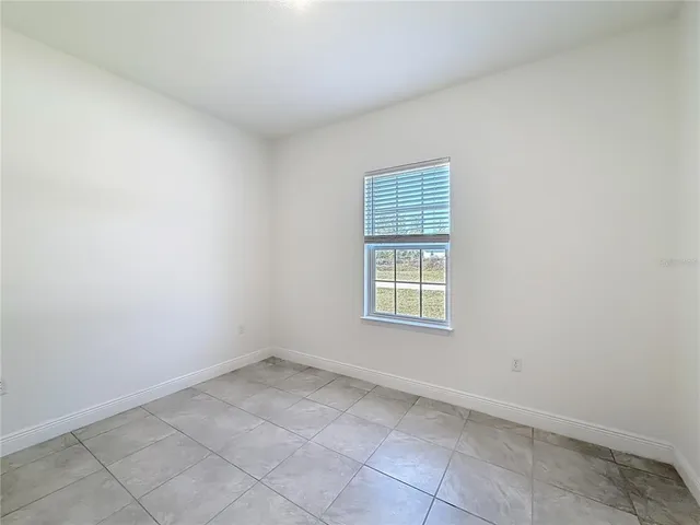 an empty room with a empty space and windows