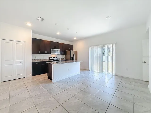 a large kitchen with kitchen island granite countertop a large counter top and appliances