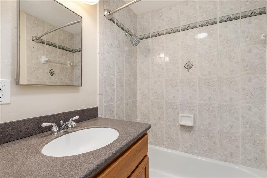 703 Spring Lake Boulevard Northwest Port Charlotte, FL 33952 - Photo 18 of 36 a bathroom with a sink and a mirror