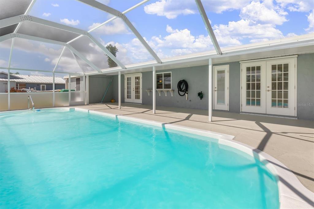 703 Spring Lake Boulevard Northwest Port Charlotte, FL 33952 - Photo 2 of 36 a house view with a sitting space and glass windows