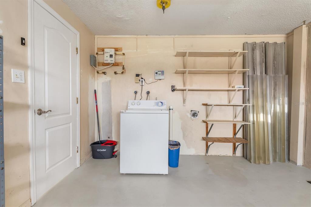 703 Spring Lake Boulevard Northwest Port Charlotte, FL 33952 - Photo 21 of 36 a utility room with dryer and washer