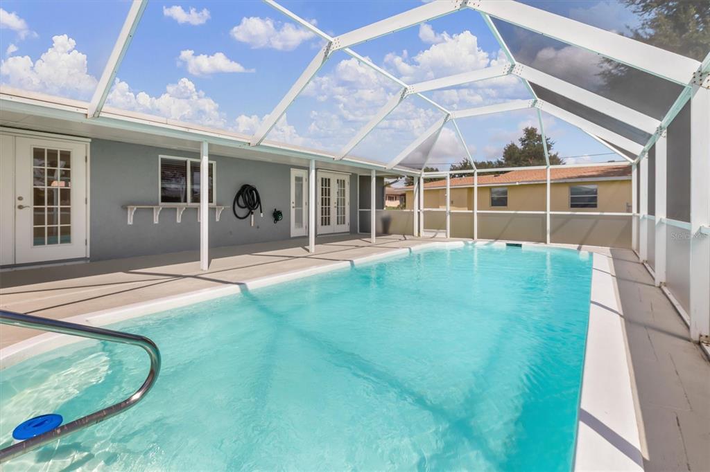 703 Spring Lake Boulevard Northwest Port Charlotte, FL 33952 - Photo 24 of 36 a backyard of a house with yard and outdoor seating